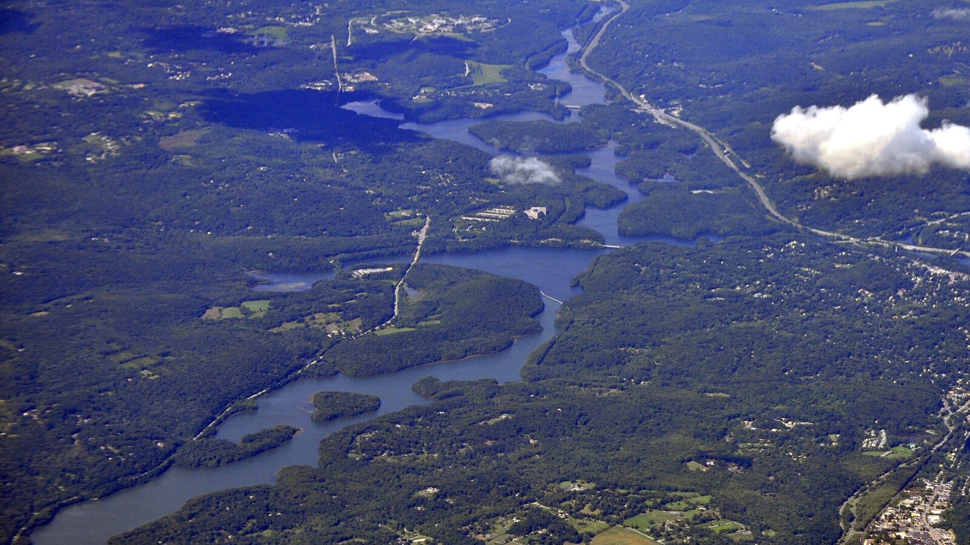 Aerial photograph of Muscoot Reservoir winding through forest in Westchester County, New York